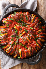 Greek cuisine Briam vegetable mix close-up in a pan. Vertical top view