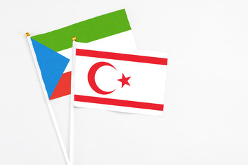 Northern Cyprus and Equatorial Guinea stick flags on white background. High quality fabric, miniature national flag. Peaceful global concept.White floor for copy space.