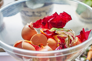 A bowl of food recycling waste on the kitchen. Closeup, selective focus