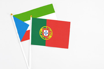 Portugal and Equatorial Guinea stick flags on white background. High quality fabric, miniature national flag. Peaceful global concept.White floor for copy space.