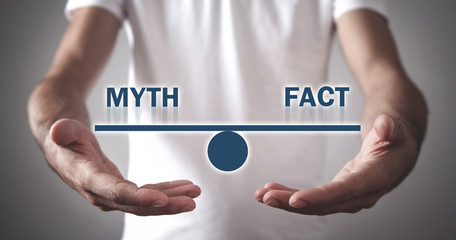 Man holding Myth and Fact balance.