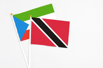 Trinidad And Tobago and Equatorial Guinea stick flags on white background. High quality fabric, miniature national flag. Peaceful global concept.White floor for copy space.