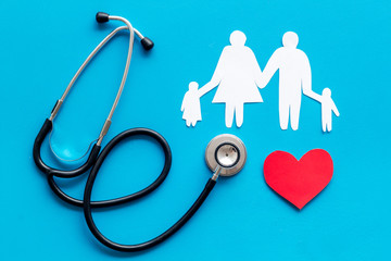 Family health care concept. Heart icon and stethoscope on blue background top view