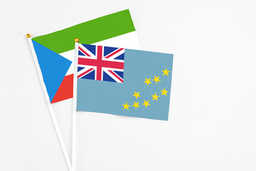 Tuvalu and Equatorial Guinea stick flags on white background. High quality fabric, miniature national flag. Peaceful global concept.White floor for copy space.