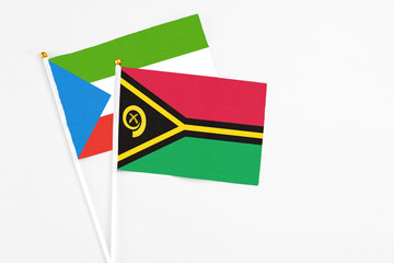 Vanuatu and Equatorial Guinea stick flags on white background. High quality fabric, miniature national flag. Peaceful global concept.White floor for copy space.