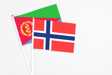 Bouvet Islands and Eritrea stick flags on white background. High quality fabric, miniature national flag. Peaceful global concept.White floor for copy space.