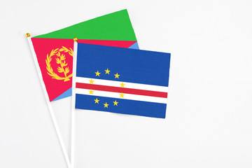 Cape Verde and Eritrea stick flags on white background. High quality fabric, miniature national flag. Peaceful global concept.White floor for copy space.