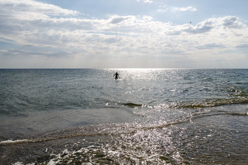 sea, sky, silhouette of man in the sea