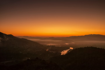 Mountain view morning above Kok river around with sea of mist, mountain and yellow light in the sky background, sunrise at Wat Tha Ton, Tha Ton, Fang, Chiang Mai, Thailand.