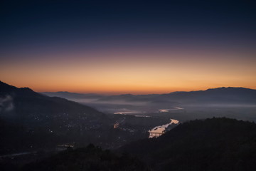 Mountain view early morning above Kok river around with sea of mist, mountain and purple light in the sky background, sunrise at Wat Tha Ton, Tha Ton, Fang, Chiang Mai, Thailand.