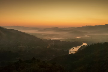 Mountain view morning above Kok river around with sea of mist, mountain and yellow light in the sky background, sunrise at Wat Tha Ton, Tha Ton, Fang, Chiang Mai, Thailand.