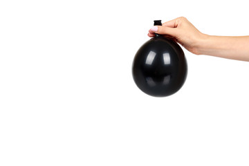 Naklejka na ściany i meble Hand with black inflateble balloon, party event decoration, glossy ball.