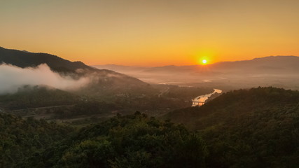 Mountain view panorama morning above Kok river around with sea of mist, mountain and yellow light in the sky background, sunrise at Wat Tha Ton, Tha Ton, Fang, Chiang Mai, Thailand.