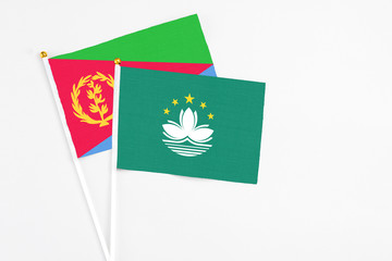 Macao and Eritrea stick flags on white background. High quality fabric, miniature national flag. Peaceful global concept.White floor for copy space.