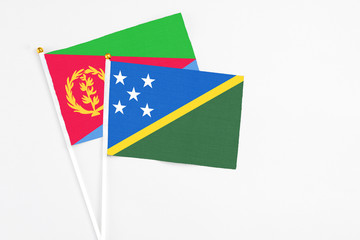 Solomon Islands and Eritrea stick flags on white background. High quality fabric, miniature...