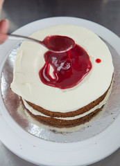 making a cake with red filling
