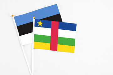 Central African Republic and Estonia stick flags on white background. High quality fabric, miniature national flag. Peaceful global concept.White floor for copy space.