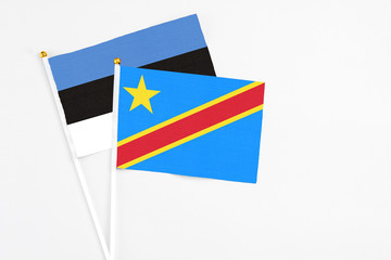 Congo and Estonia stick flags on white background. High quality fabric, miniature national flag. Peaceful global concept.White floor for copy space.