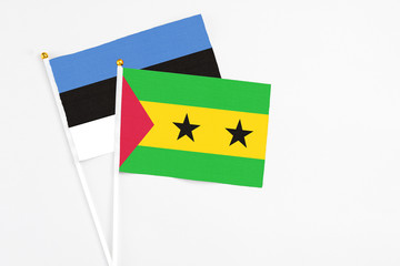 Sao Tome And Principe and Estonia stick flags on white background. High quality fabric, miniature national flag. Peaceful global concept.White floor for copy space.