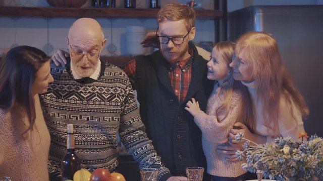 Multi-generation family gathered in kitchen having christmas meal together