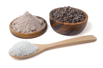 Himalayan black rock salt, Indian Black salt, Hawaiian Black Lava Salt  in a wooden bowl and wooden spoon isolated on white background with clipping path