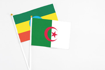 Algeria and Ethiopia stick flags on white background. High quality fabric, miniature national flag....