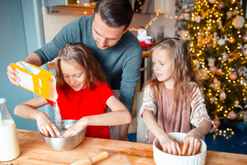 Family baking gingerbread cookies on Xmas vacation