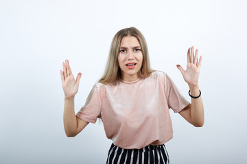 Fototapeta na wymiar Young beautiful caucasian lady over white background in studio looking irritated and angry expressing negative emotion, annoyed with someone.