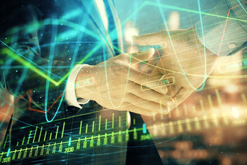Double exposure of financial chart on cityscape background with two businessmen handshake. Concept of financial analysis and investment opportunities