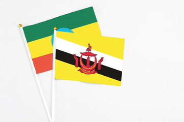 Brunei and Ethiopia stick flags on white background. High quality fabric, miniature national flag. Peaceful global concept.White floor for copy space.
