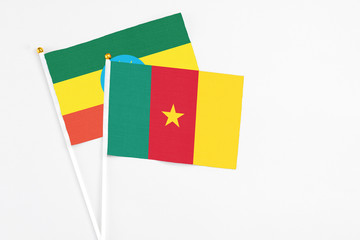 Cameroon and Ethiopia stick flags on white background. High quality fabric, miniature national flag. Peaceful global concept.White floor for copy space.