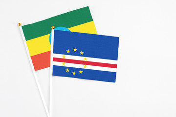 Cape Verde and Ethiopia stick flags on white background. High quality fabric, miniature national flag. Peaceful global concept.White floor for copy space.