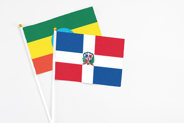 Dominican Republic and Ethiopia stick flags on white background. High quality fabric, miniature national flag. Peaceful global concept.White floor for copy space.
