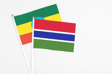 Gambia and Ethiopia stick flags on white background. High quality fabric, miniature national flag. Peaceful global concept.White floor for copy space.