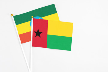 Guinea Bissau and Ethiopia stick flags on white background. High quality fabric, miniature national flag. Peaceful global concept.White floor for copy space.