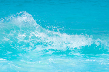 The beautiful sea wave with blue foam and turquoise color.
