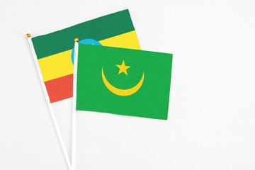 Mauritania and Ethiopia stick flags on white background. High quality fabric, miniature national flag. Peaceful global concept.White floor for copy space.