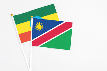 Namibia and Ethiopia stick flags on white background. High quality fabric, miniature national flag. Peaceful global concept.White floor for copy space.