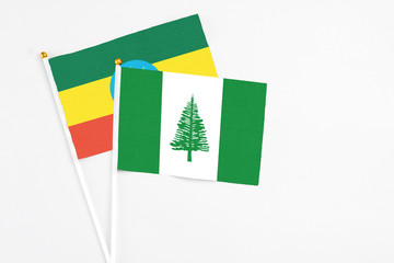 Norfolk Island and Ethiopia stick flags on white background. High quality fabric, miniature national flag. Peaceful global concept.White floor for copy space.