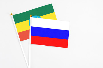 Russia and Ethiopia stick flags on white background. High quality fabric, miniature national flag. Peaceful global concept.White floor for copy space.