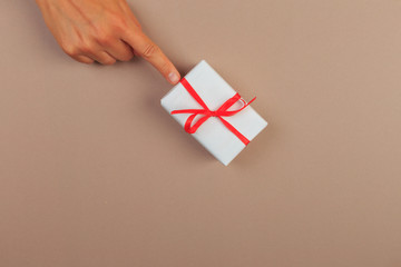 Obraz premium gift in female hands on a colored background top view. - Image
