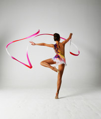 Fototapeta na wymiar girl with red ribbon in in gymnastic pose