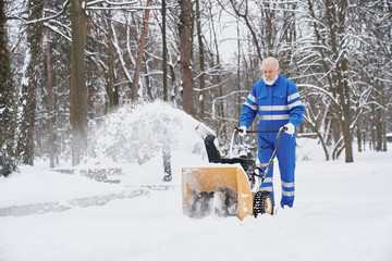 Fototapeta na wymiar Man cleaning snow with snowblover.