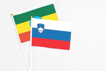 Slovenia and Ethiopia stick flags on white background. High quality fabric, miniature national flag. Peaceful global concept.White floor for copy space.