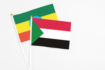 Sudan and Ethiopia stick flags on white background. High quality fabric, miniature national flag. Peaceful global concept.White floor for copy space.