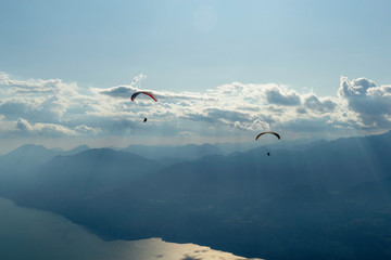 Paragliders flying in mount Baldo, lake Garda, Italy