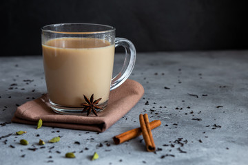 Indian tea masala chai with spices in a glass mug