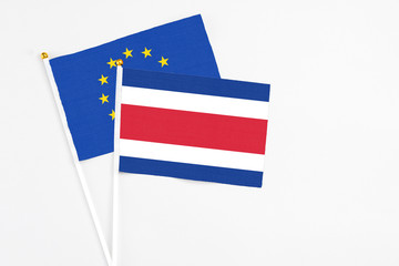 Costa Rica and European Union stick flags on white background. High quality fabric, miniature national flag. Peaceful global concept.White floor for copy space.