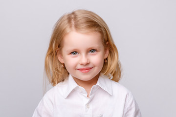 portrait of a cute little girl in a white T-shirt smile isolated on white background
