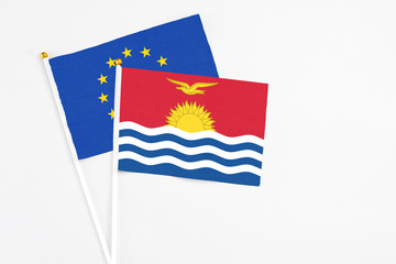 Kiribati and European Union stick flags on white background. High quality fabric, miniature national flag. Peaceful global concept.White floor for copy space.